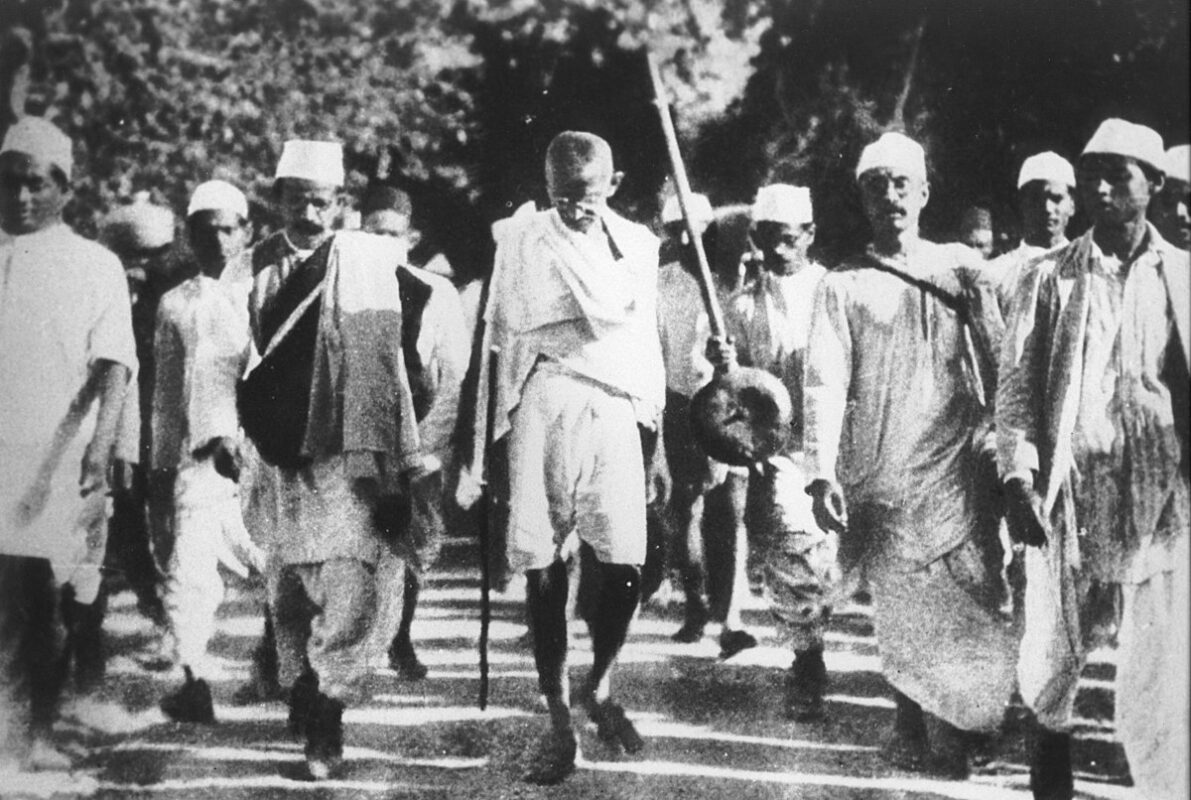 Mahatma Gandhi leading a non-violent protest for Indian independence, a pivotal moment in challenging British colonial rule